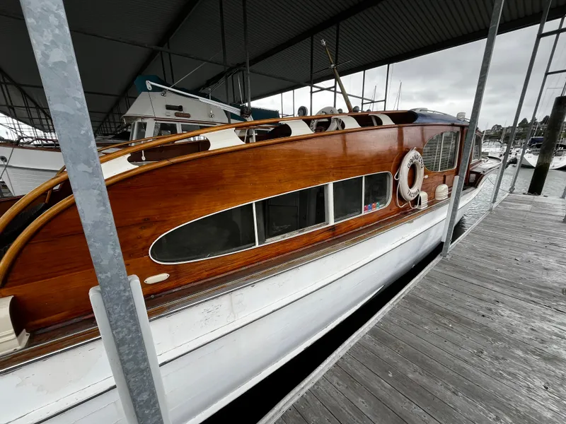 Slide: The Image of 1948 Chris-Craft Double Cabin boat docked under a covered marina. - 8