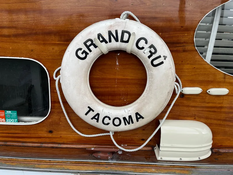 Slide: The Image of 1948 Chris-Craft Double Cabin with "Grand Cru Tacoma" life preserver on wooden exterior. - 9