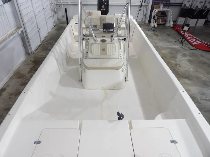 Slide: The Image of 2013 Carolina Skiff 238 DLV boat interior, featuring center console and spacious deck. - 10