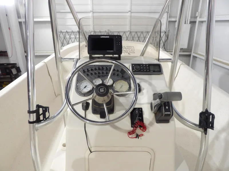Slide: The Image of 2013 Carolina Skiff 238 DLV boat console with steering wheel and navigation equipment. - 12