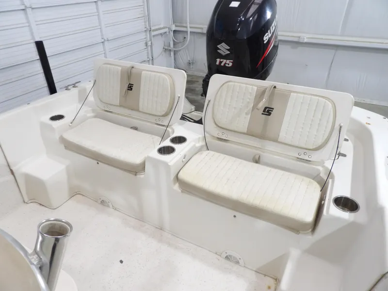 Slide: The Image of 2013 Carolina Skiff 238 DLV boat interior with seating and Suzuki 175 outboard motor. - 15