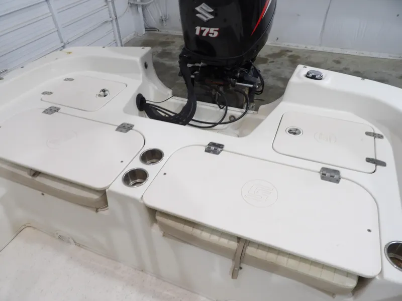 Slide: The Image of 2013 Carolina Skiff 238 DLV boat with Suzuki 175 outboard motor in a garage. - 16