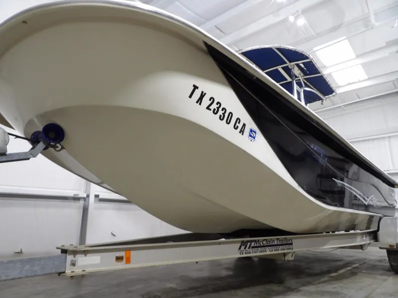 Slide: The Image of 2013 Carolina Skiff 238 DLV boat on trailer in indoor storage. - 5