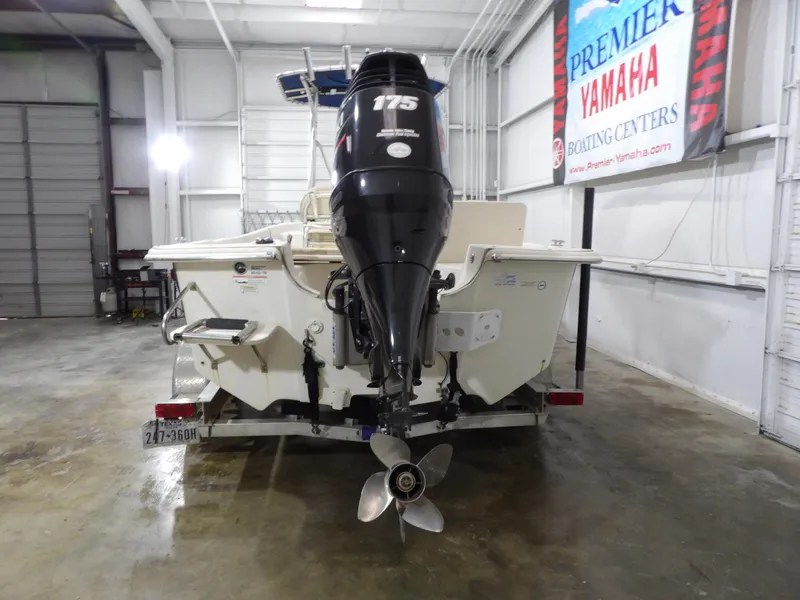 Slide: The Image of 2013 Carolina Skiff 238 DLV boat with 175 HP engine in a showroom. - 8