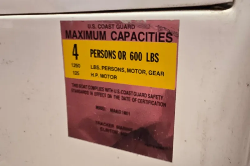 Slide: The Image of Sticker on 2008 Mako Inshore 1801 showing U.S. Coast Guard capacity limits. - 17