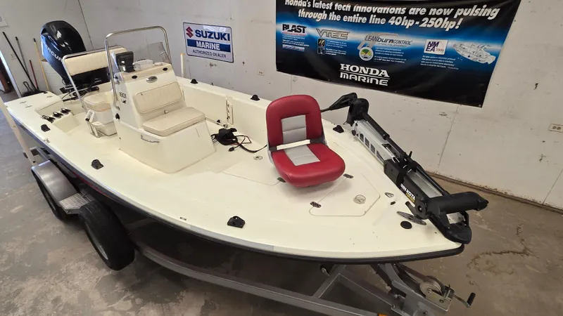 Slide: The Image of 2008 Mako Inshore 1801 boat on trailer, featuring red seat and Suzuki Marine engine. - 3