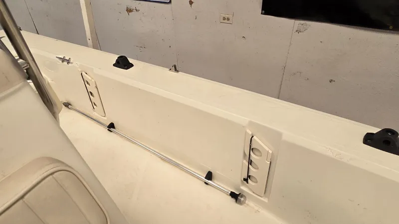 Slide: The Image of 2008 Mako Inshore 1801 boat interior with rod holder and storage compartments. - 9