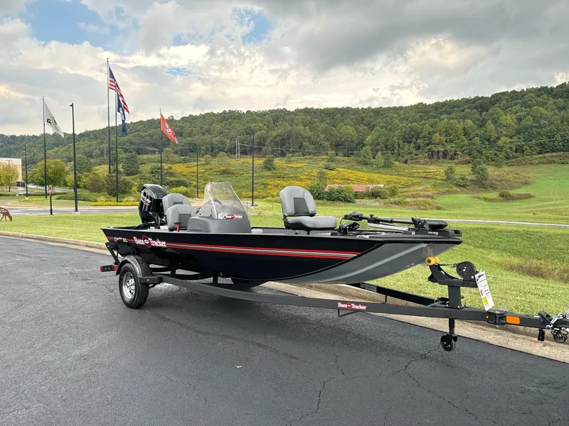 Slide: The Image of 2025 Tracker Bass Tracker Classic XL boat on trailer, parked outdoors with scenic background. - 2