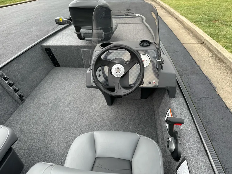 Slide: The Image of 2025 Tracker Bass Tracker Classic XL boat interior with steering wheel and dashboard. - 4