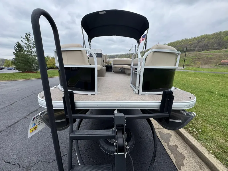 Slide: The Image of 2025 Sun Tracker Party Barge 16 DLX pontoon boat on trailer, rear view. - 4