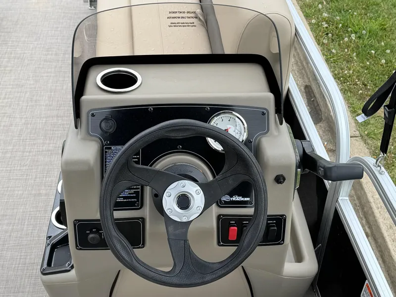 Slide: The Image of 2025 Sun Tracker Party Barge 16 DLX steering console with cup holder and gauge. - 5