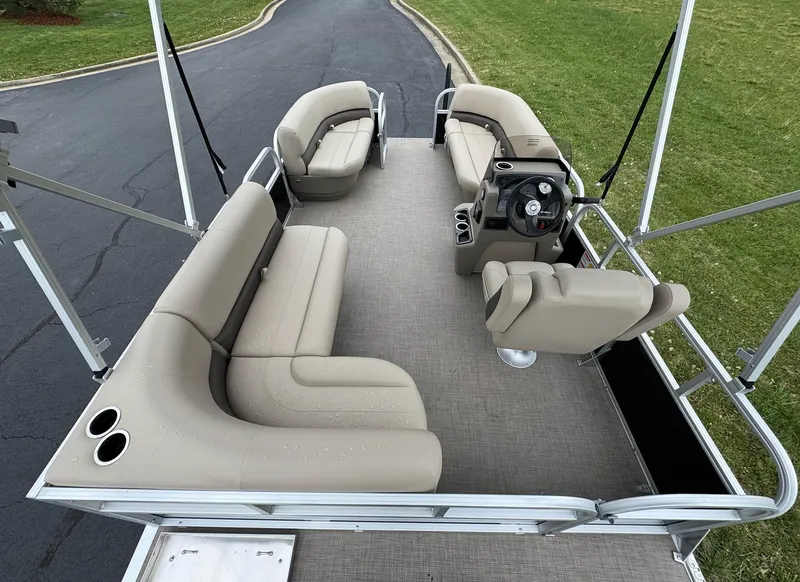 Slide: The Image of 2025 Sun Tracker Party Barge 16 DLX pontoon boat with beige seating and steering console. - 7