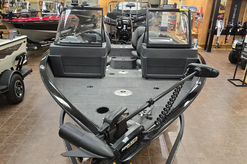 Slide: The Image of 2025 Tracker Pro Guide V-175 WT boat displayed in showroom, featuring dual consoles and trolling motor. - 2