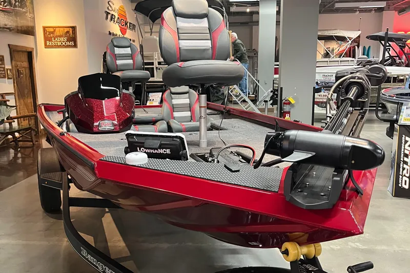 Slide: The Image of 2025 Ranger RT178 boat, red with advanced navigation, displayed indoors. - 2