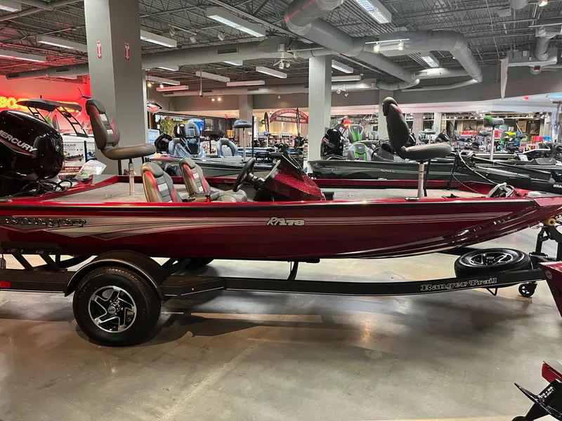 Slide: The Image of 2025 Ranger RT178 boat on display in a showroom, featuring a sleek red design. - 3