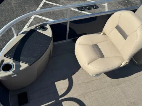 Slide: The Image of 2025 Sun Tracker Bass Buggy 18 DLX pontoon boat interior with beige seating. - 10