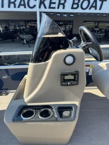 Slide: The Image of 2025 Sun Tracker Bass Buggy 18 DLX console with steering wheel and cup holders. - 12