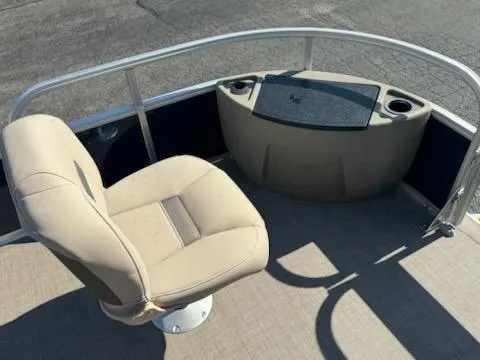 Slide: The Image of 2025 Sun Tracker Bass Buggy 18 DLX pontoon boat with beige seating and console. - 9
