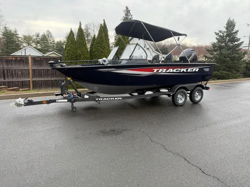 Slide: The Image of 2025 Tracker Targa V-18 Combo boat on trailer, parked outdoors. - 5