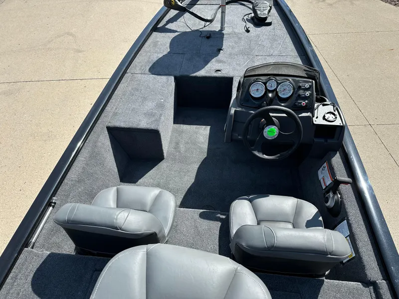 Slide: The Image of 2025 Tracker Pro 170 boat interior with steering console and two gray seats. - 6