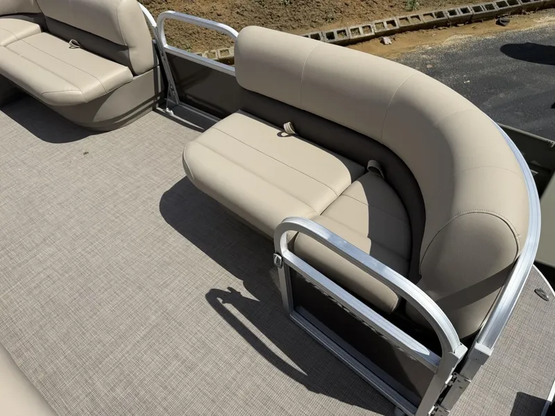 Slide: The Image of 2025 Sun Tracker Party Barge 16 DLX seating area with beige upholstery and metal railings. - 8