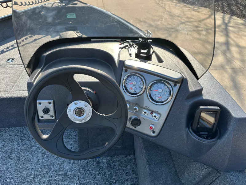 Slide: The Image of 2025 Tracker Pro Guide V-16 SC boat dashboard with steering wheel and gauges. - 5