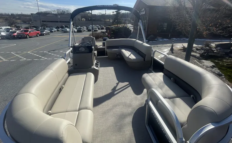 Slide: The Image of 2025 Sun Tracker Party Barge 16 DLX pontoon boat with spacious seating in a parking lot. - 4