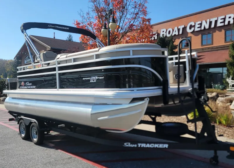 Slide: The Image of 2025 Sun Tracker SportFish 20 DLX pontoon boat on trailer outside dealership. - 4