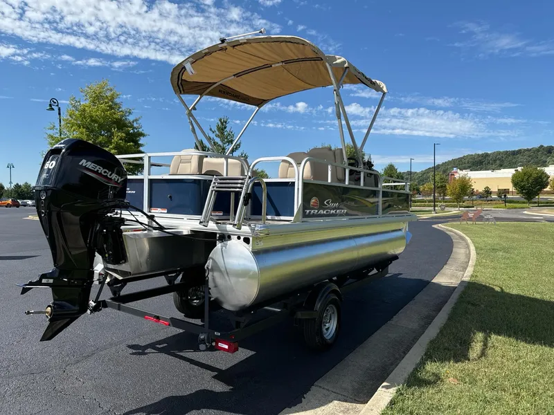 Slide: The Image of 2025 Sun Tracker Bass Buggy 18 DLX pontoon boat with canopy on a trailer. - 3