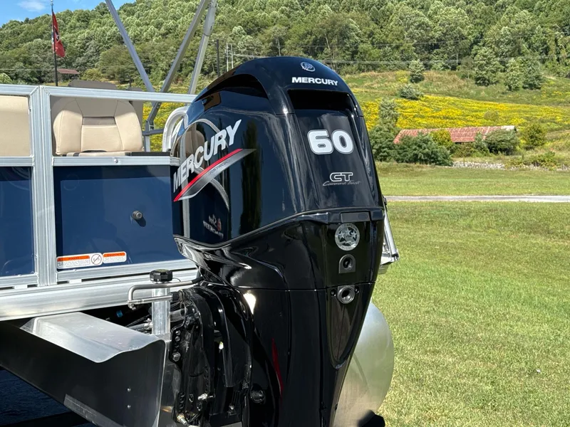 Slide: The Image of 2025 Sun Tracker Bass Buggy 18 DLX with Mercury 60 GT outboard motor in scenic setting. - 5