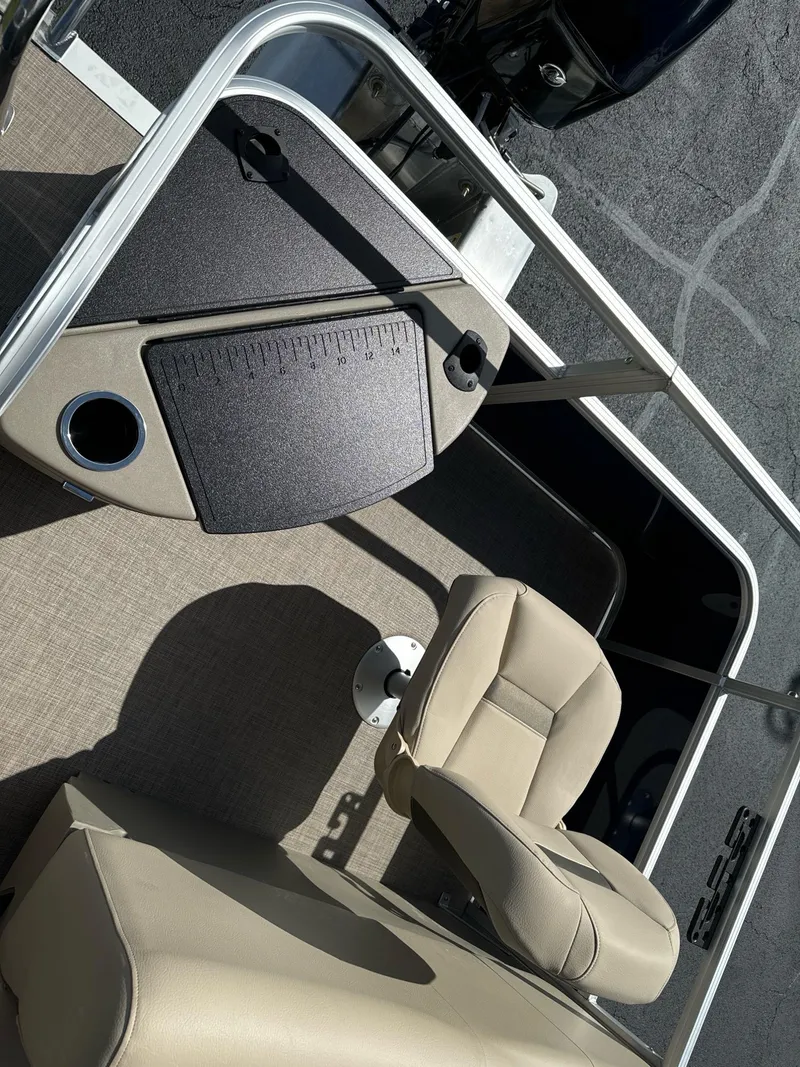 Slide: The Image of 2025 Sun Tracker Bass Buggy 18 DLX interior with beige seating and control panel. - 7