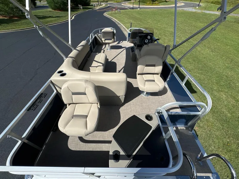 Slide: The Image of 2025 Sun Tracker Bass Buggy 18 DLX pontoon boat with spacious seating and modern design. - 8