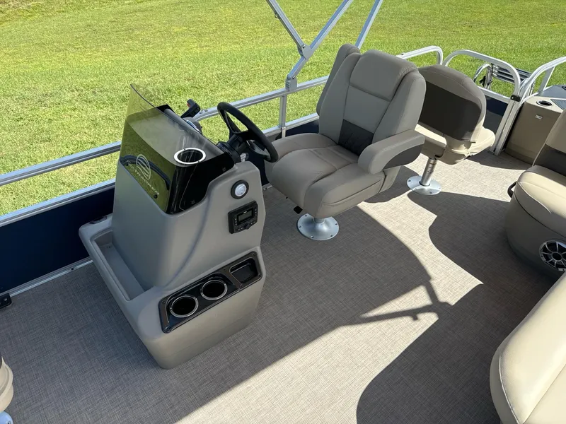 Slide: The Image of 2025 Sun Tracker Bass Buggy 18 DLX pontoon boat interior with steering console and seating. - 9