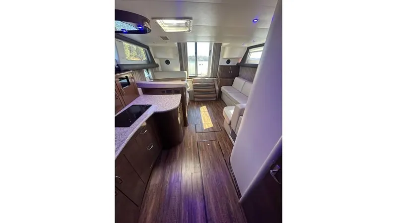 Slide: The Image of Interior of 2009 Carver 36 Mariner yacht, featuring modern kitchen and seating area. - 10