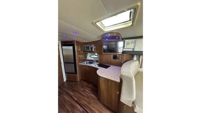 Slide: The Image of Interior of 2009 Carver 36 Mariner yacht with modern kitchen amenities. - 11