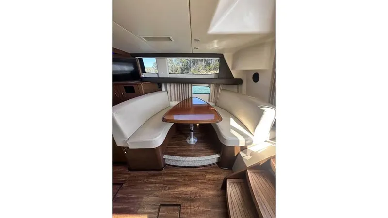 Slide: The Image of 2009 Carver 36 Mariner interior with dining area and wooden flooring. - 13