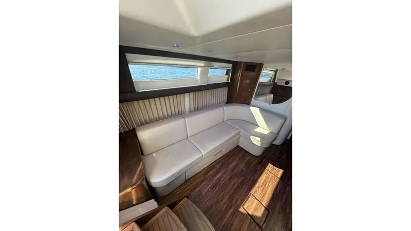 Slide: The Image of Interior of 2009 Carver 36 Mariner yacht with white seating and wood flooring. - 14