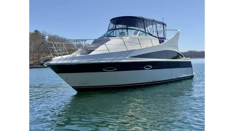 Slide: The Image of 2009 Carver 36 Mariner yacht on calm water, featuring sleek design and spacious deck. - 2