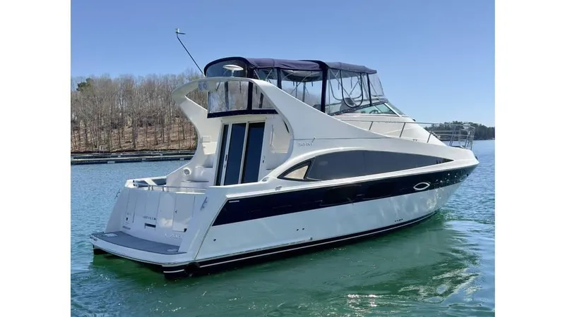 Slide: The Image of 2009 Carver 36 Mariner yacht on calm water, featuring sleek design and spacious deck. - 3