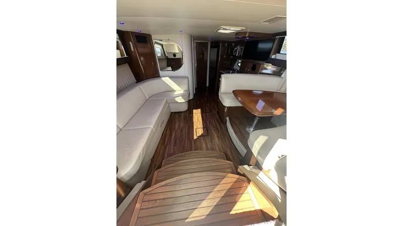 Slide: The Image of Interior of 2009 Carver 36 Mariner yacht with elegant seating and wooden flooring. - 9