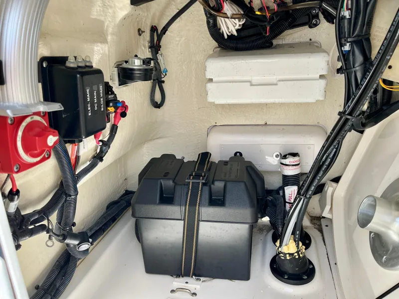 Slide: The Image of Interior view of a 2022 Boston Whaler 17 Montauk boat, showcasing wiring and battery compartment. - 12
