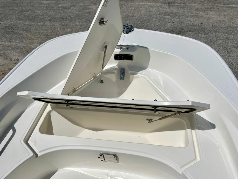 Slide: The Image of 2022 Boston Whaler 17 Montauk boat with open storage compartment. - 13