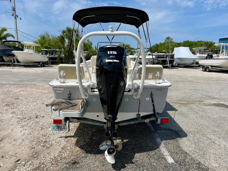 Slide: The Image of 2022 Boston Whaler 17 Montauk boat with 115 HP Mercury engine, parked outdoors. - 7