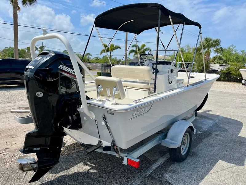 Slide: The Image of 2022 Boston Whaler 17 Montauk boat on trailer with canopy and Mercury outboard motor. - 8