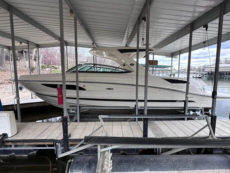 Slide: The Image of 2014 Sea Ray 350 SLX boat docked under a covered marina. - 0