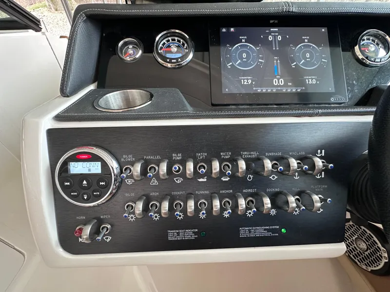 Slide: The Image of Control panel of a 2014 Sea Ray 350 SLX boat with gauges and switches. - 10