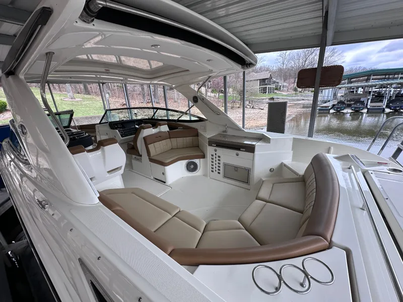 Slide: The Image of 2014 Sea Ray 350 SLX boat interior with spacious seating and modern amenities. - 15