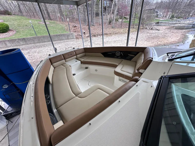 Slide: The Image of 2014 Sea Ray 350 SLX boat interior with beige seating and brown accents. - 17