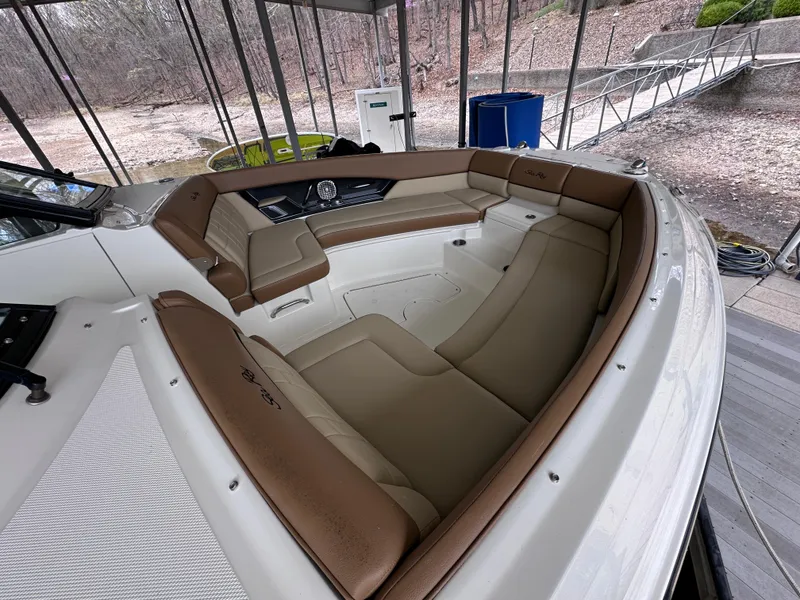 Slide: The Image of 2014 Sea Ray 350 SLX boat with spacious tan leather seating in docked position. - 18