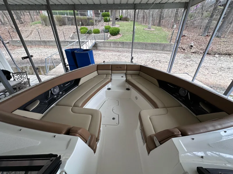Slide: The Image of 2014 Sea Ray 350 SLX boat with spacious seating in a covered dock area. - 19